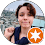 Smiling person outdoors with a star badge