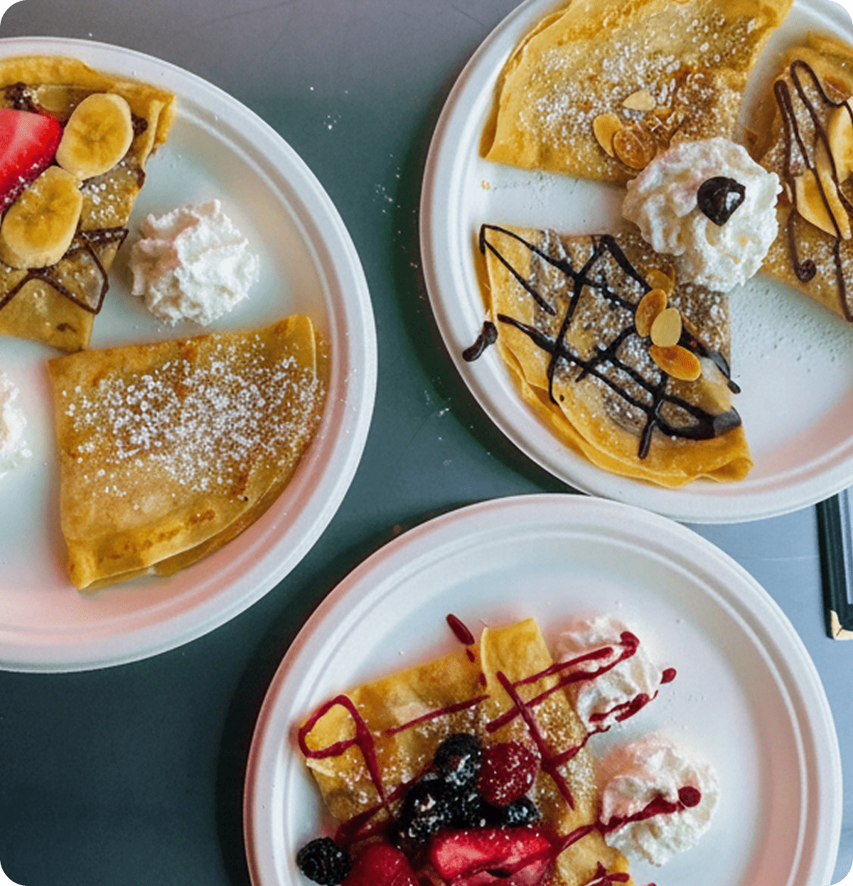 Assorted crepes with toppings on plates
